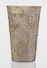 Glass decorated with a leaf and fruit motif;, transparent, colorless glass with relief decoration