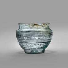 Bowl with Greek inscription. Glass bowl of transparent light blue glass with an uneven rim edge,