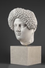 Portrait of a Roman woman, head with a broad face and an elaborate hairstyle: hair twisted into