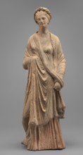 Female Figurine, Standing woman dressed in a long robe, slightly pleated and belted high under the