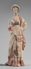 Figurine of a maenad, ca. 3rd–2nd century BC. A young woman standing in a wreath tied with a ribbon
