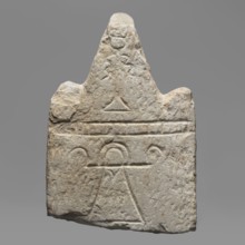 Votive stele with the sign Tanit, unknown Carthaginian workshop. Upper part of a stele with