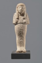 Ushabti, Mummy-shaped figurine made of limestone. Arms crossed on the chest, right folded over