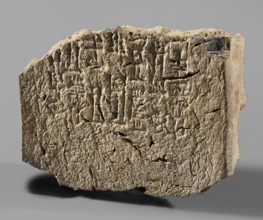Fragment of a burnt clay brick with fragments of 7 lines of a cuneiform inscription, impressed with