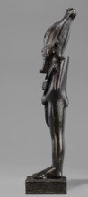 Figurine of the god Osiris. Statuette of a standing Osiris wrapped in a long, tight-fitting robe