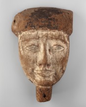 Sarcophagus mask of a deceased man. Creamy, elongated face, almond-shaped eyes, long straight nose.