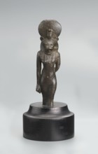 Sekhmet figurine, lion-headed goddess shown standing or walking. The figure has a lioness' head in