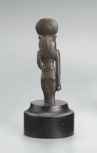 Sekhmet figurine, lion-headed goddess shown standing or walking; lioness head with tripartite wig
