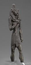 Figurine of the god Mahes. Figurine of a striding man with a lion's head. The lion's head is set