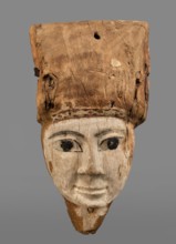Sarcophagus mask with fragment of a high wig above the forehead, decorated on the edge of the