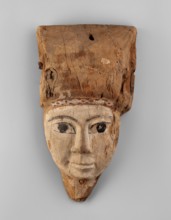 Sarcophagus mask with fragment of a high wig above the forehead, decorated on the edge of the