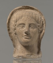 Votive head, Head of a young man covered with a shawl, from under which hair emerges in the form of