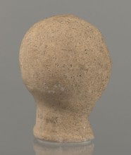 Votive head, Head of a young man covered with a shawl, from under which hair emerges in the form of