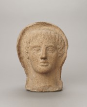 Votive head, Head of a young man covered with a shawl, from under which hair emerges in the form of