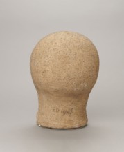 Votive head, Head of a young man covered with a shawl, from under which hair emerges in the form of