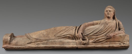 Sarcophagus lid, The deceased is depicted in a semi-reclining position, resting his left forearm on
