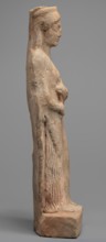 Figurine of a woman standing on a rectangular base. The woman is dressed in a finely pleated chiton