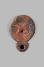 Lamp decorated with a depiction of a dog; unknown eastern workshop; single-burner oil lamp; dogs