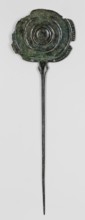 Pin, unknown Luristan workshop. A long pin terminating in a head in the form of an oval shield with