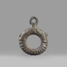 Decorative pendant from a horse harness, unknown Near Eastern workshop. The pendant is in the form