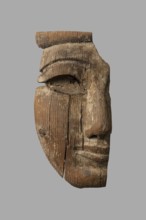 Fragment of a sarcophagus mask. Preserved half of a face made from a single piece of wood. Above