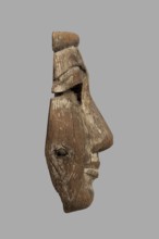 Fragment of a sarcophagus mask. Preserved half of a face made from a single piece of wood. Above