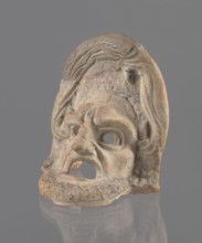 Tragic mask, terracotta, tragic/theater mask. Tragic mask depicting a male face, likely a