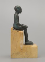 Figurine of Imhotep: seated Imhotep holding an unrolled papyrus on his lap, palms of both hands