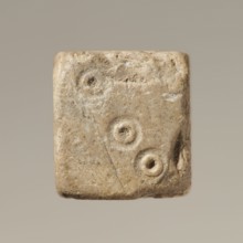 Six-sided dice with pips 1–6 shown as hollow circles and dots; material unspecified; maker and