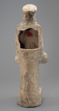 Female terracotta figurine of a standing woman positioned frontally on a quadrangular base. The