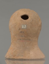 Votive female head, Female head wearing a wreath, from under which lush locks of hair curl down the