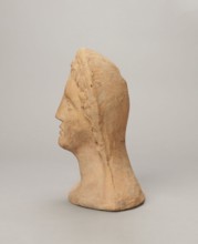 Votive female head, Female head wearing a wreath, from under which lush locks of hair curl down the