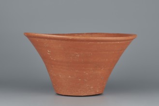 Deep, cup-shaped clay bowl with a slightly convex bottom and sides arching upwards; straight, flat,