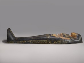 Lid of an anthropoid sarcophagus of a woman with clearly modeled legs. The head is sculpturally