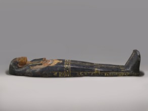 Lid of an anthropoid sarcophagus of a woman with clearly modeled legs. The head is sculpturally
