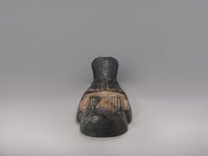 Lid of an anthropoid sarcophagus of a woman with clearly modeled legs. The head is sculpturally