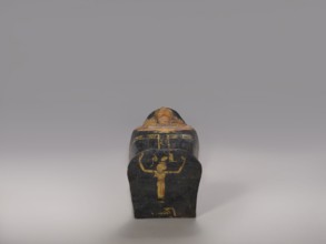 Lid of an anthropoid sarcophagus of a woman with clearly modeled legs. The head is sculpturally