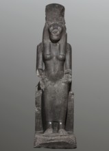 Statue of the goddess Sekhmet. Woman with a lioness's head seated on a throne, dressed in a long