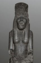 Statue of the goddess Sekhmet. Woman with a lioness's head seated on a throne, dressed in a long,