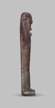Ushabti, A shabti figurine dressed in a shroud stands on a base. On the head is a smooth wig,