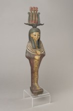Osiris, Osiris mythology. Figurine in the form of a human mummy wearing a hemhem crown with ram's