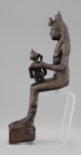 Figurine of the goddess Isis nursing Horus. The figurine depicts a seated Isis with the child Horus