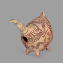 Vessel in the shape of a fantastic animal. The neck is long and thin, ending in a triangular,