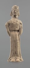 Terracotta figurine of a woman, unknown Boeotian workshop. Mold-pressed terracotta figurine of a