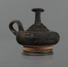 Black-finned guttus, guttus, Greek pottery, black-finned pottery. Guttus with a high foot composed