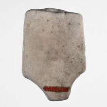 Fragment of a figurine of a woman on a bed. Flat figurine of a concubine resting on a plate