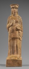 Figurine of a woman with a polos on her head, Tanagra workshop, early 5th century BC circa 480 BC,