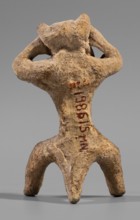 Satyr figurine, clay; depicts a satyr with a face stylized as a mask with protruding ears and two
