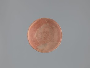 Plate, unknown Aswan workshop; flat plate on a low, ring-shaped foot. Rim poorly defined, rounded