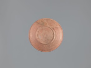 Plate, unknown Aswan workshop; flat plate on a low ring-shaped foot. Rim poorly defined, rounded at